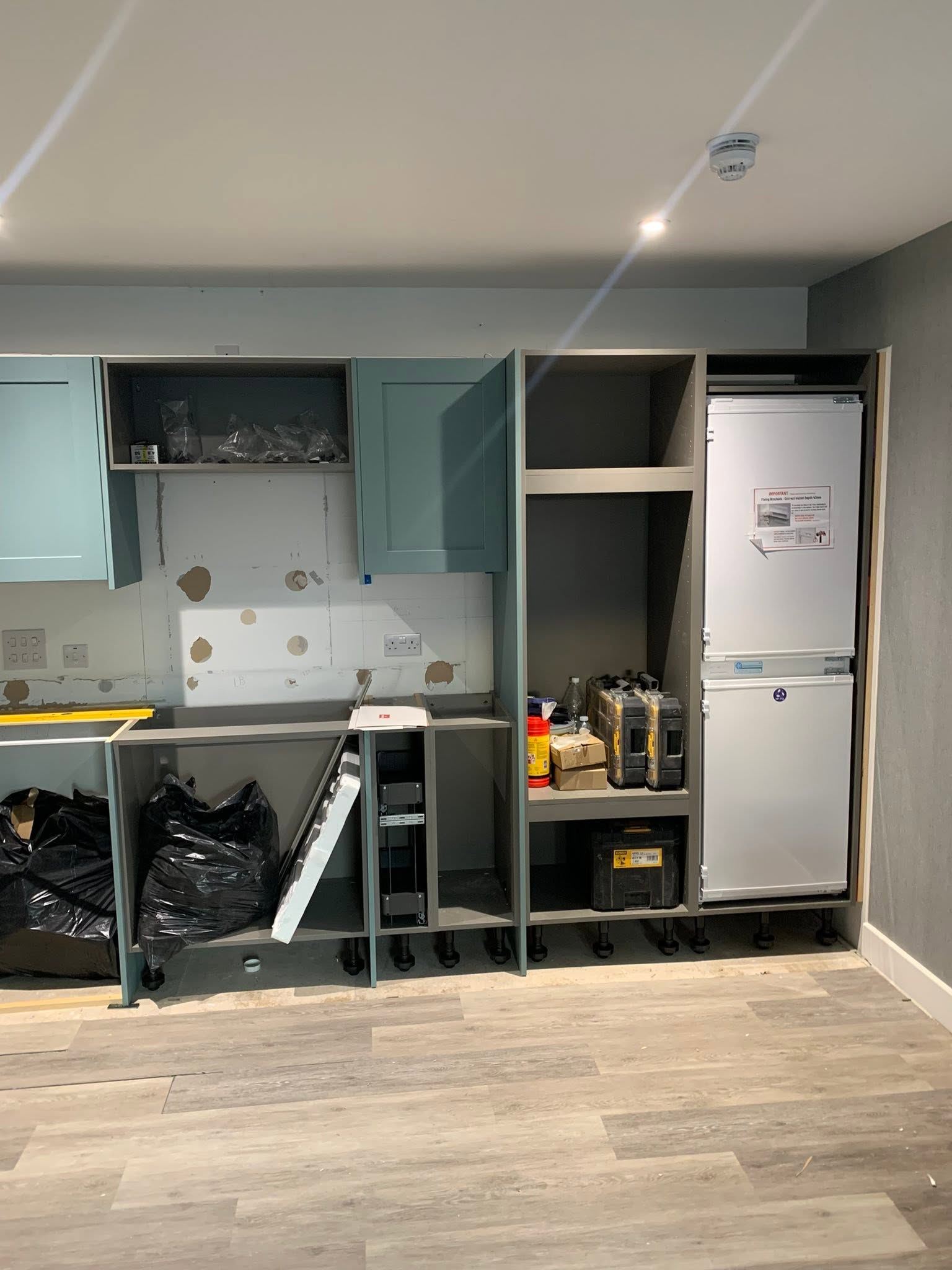 Tall units and appliance housing being installed